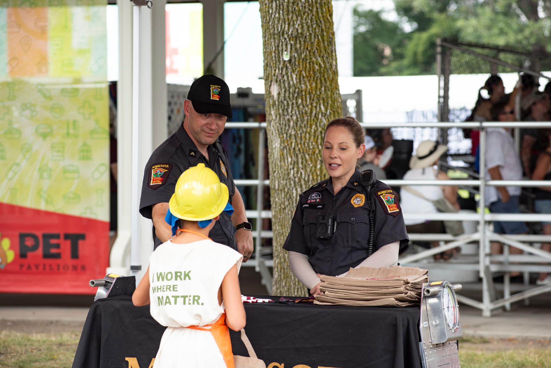 Commercial vehicle inspectors talking to child