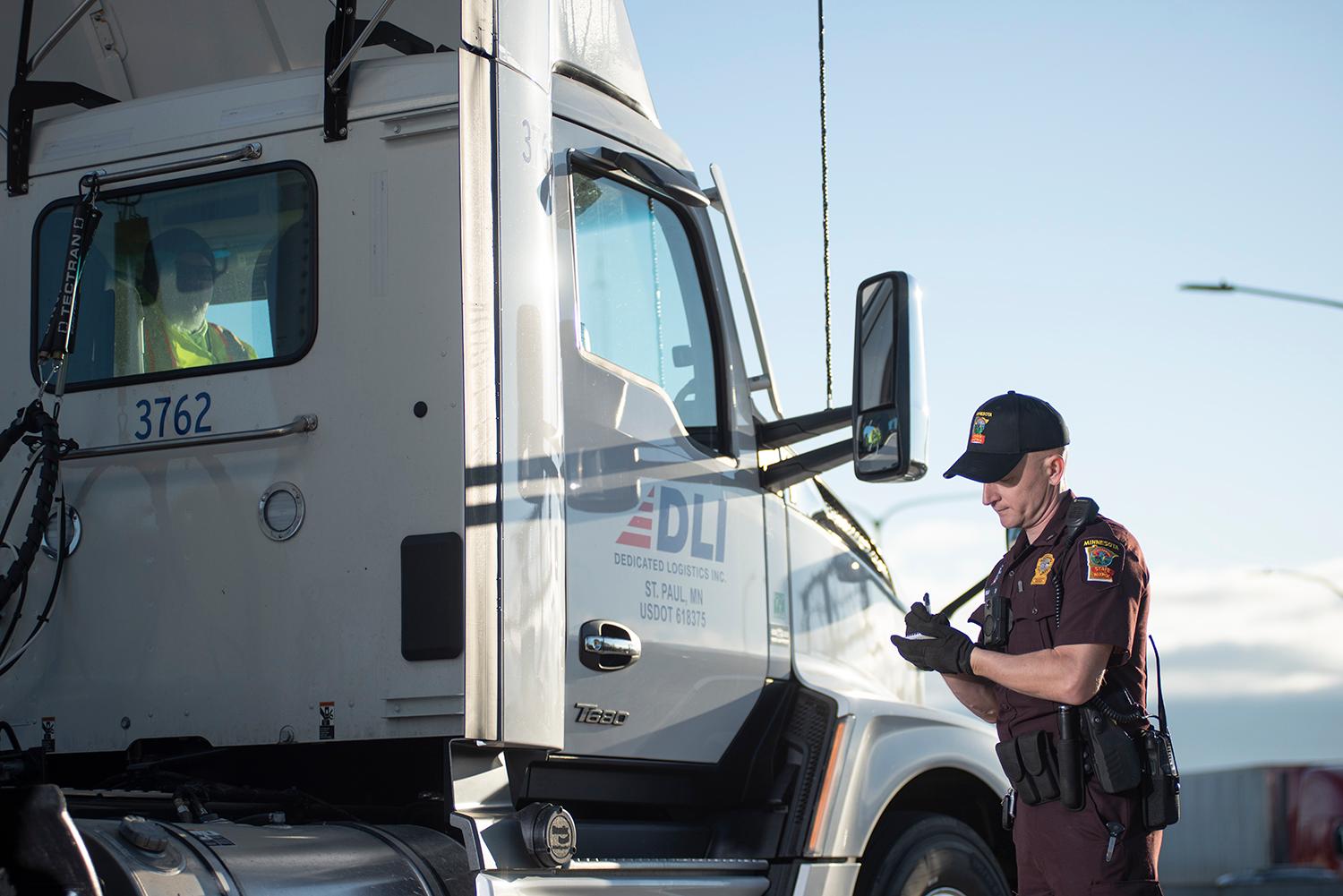 Commercial vehicle inspector writing on paper