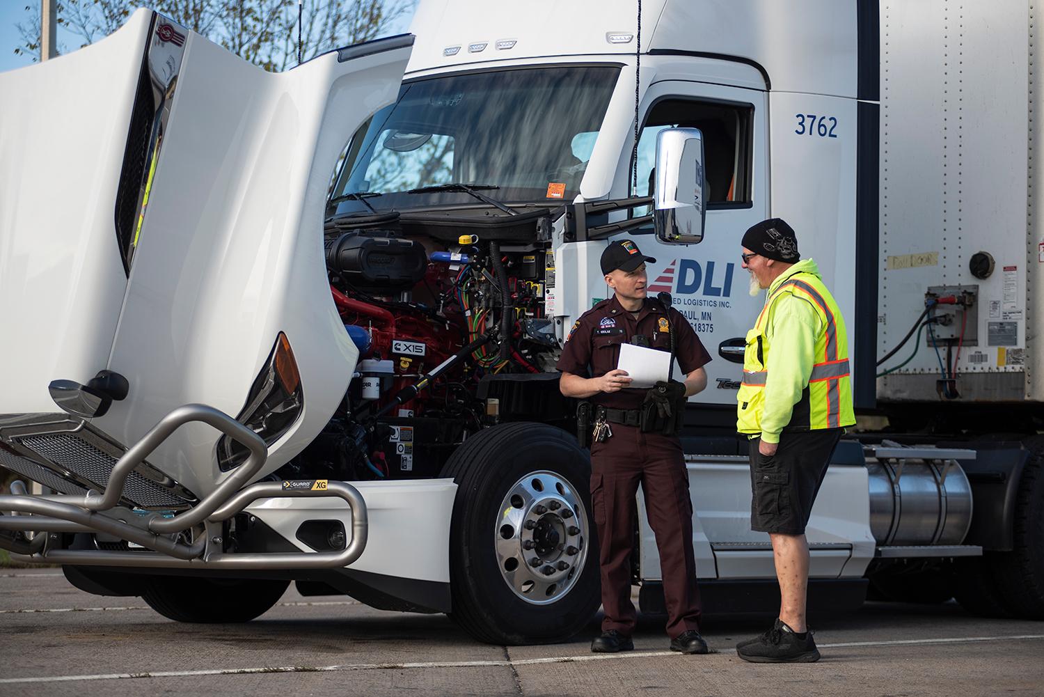 commercial vehicle inspector talking to truck driver