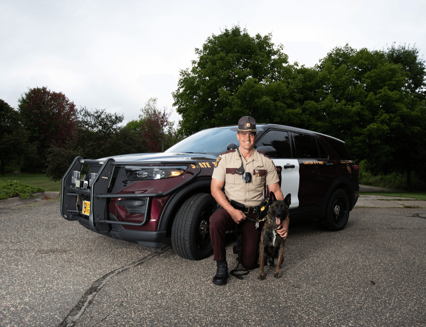 Trooper kneeling next to k-9