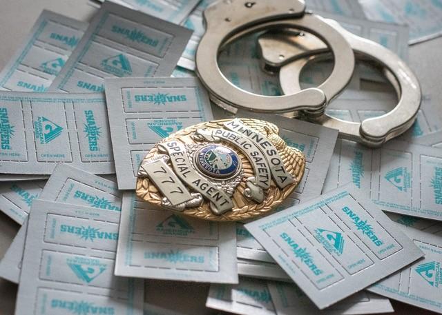 age badge, handcuffs and pull tabs