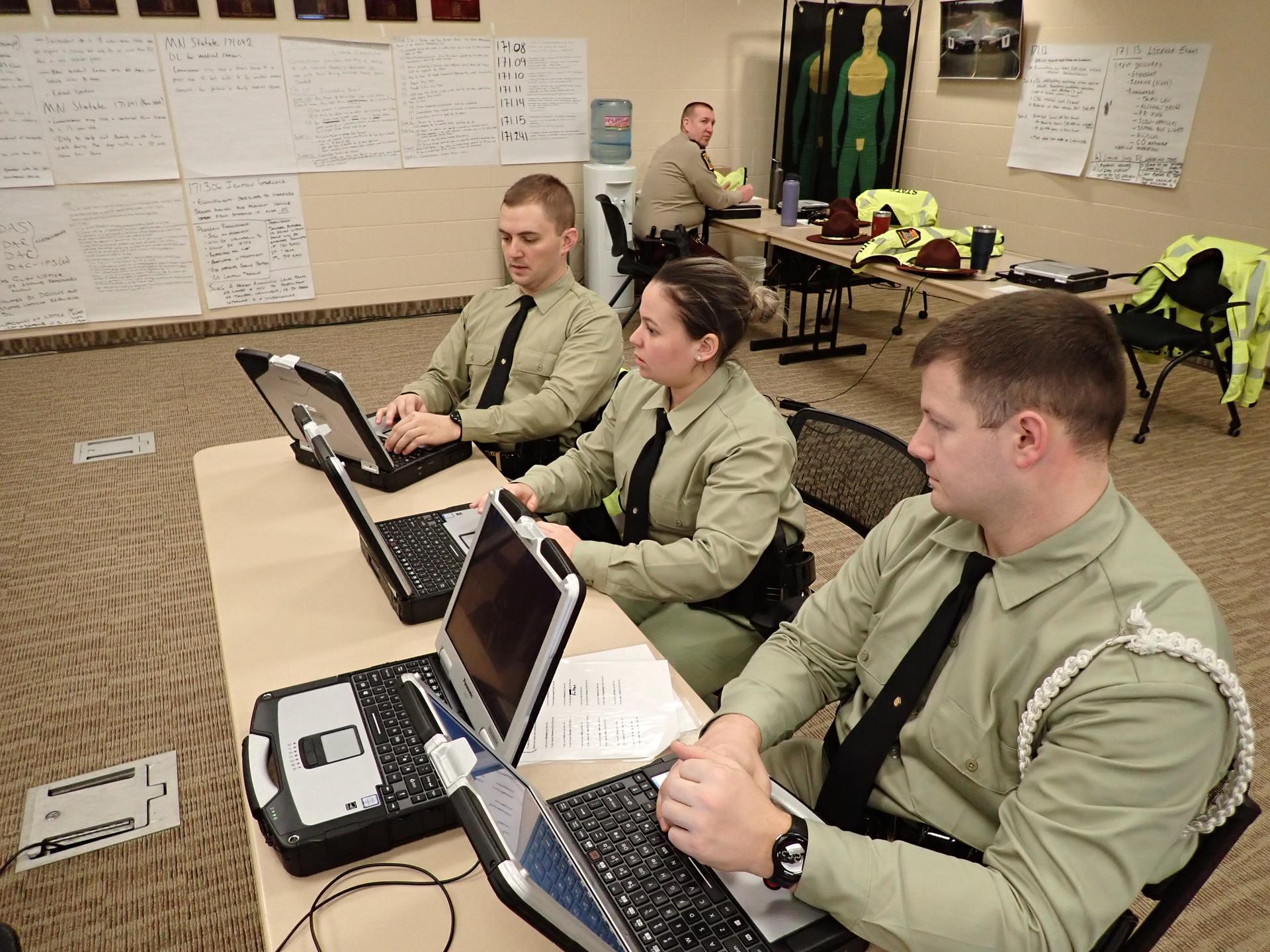 people sitting in classroom looking at computers