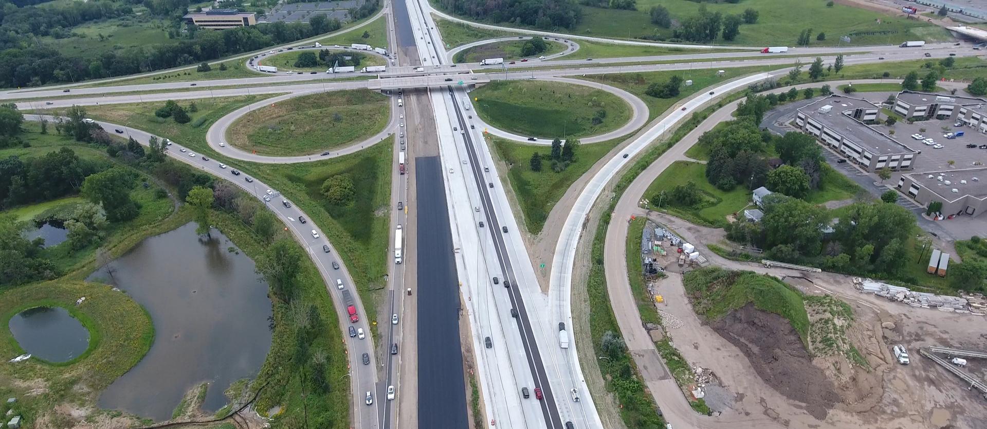 Drone photo of highway and exits with vehicles driving